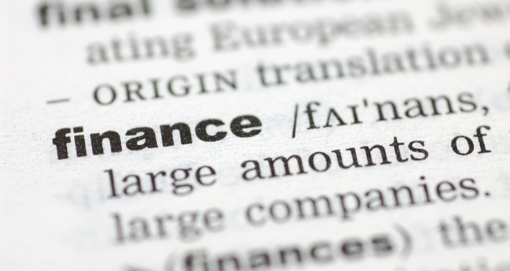 A close-up shot of a dictionary page, focused on the word "finance"